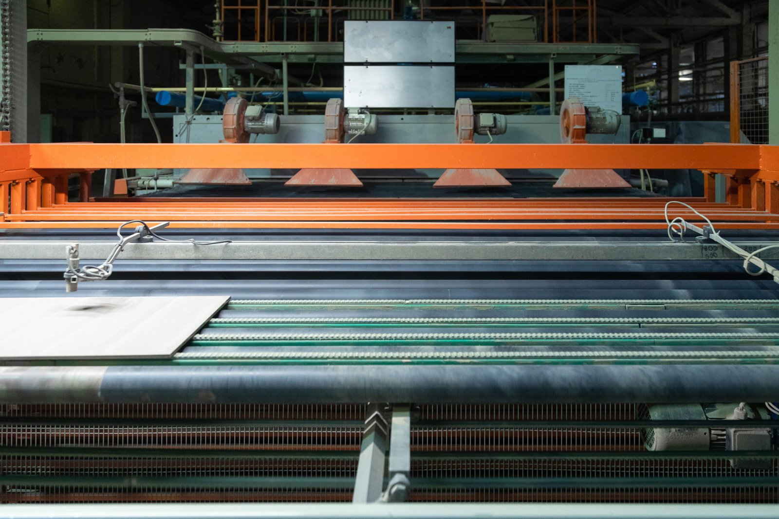 Automated denim textile weaving machines operating on a factory floor at Surya Lakshmi Cotton Mills